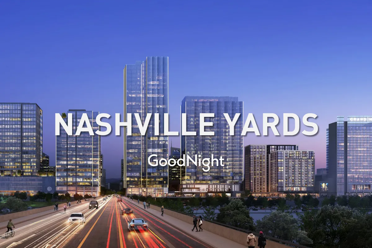 This image features tall glass buildings within a bustling cityscape, vehicles on the street, pedestrians, and a dynamic view of the skyline—capturing the urban energy of Nashville's business hubs.